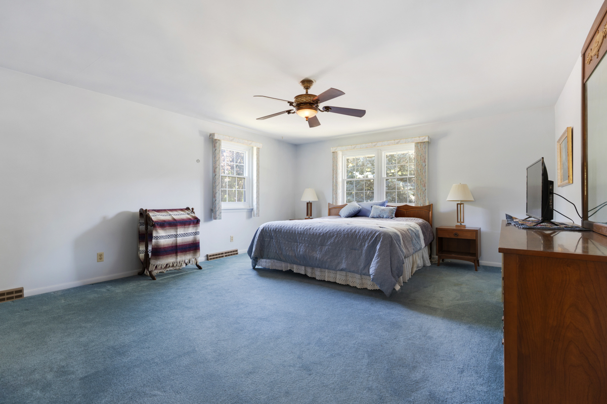 690 Stanford Drive Marengo, IL 60152 - Photo 15 of 30 a spacious bedroom with a bed and a chandelier