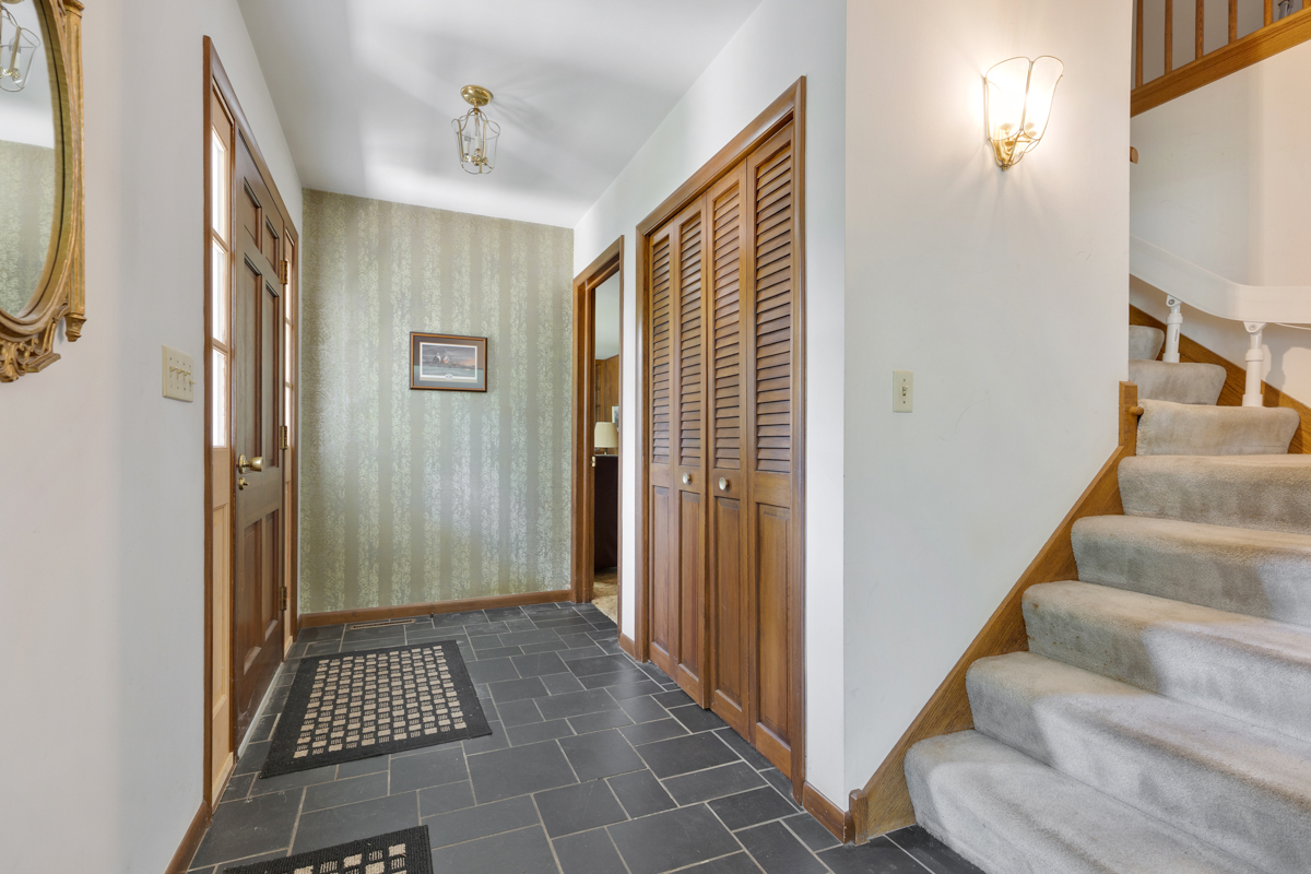 690 Stanford Drive Marengo, IL 60152 - Photo 2 of 30 a view of a hallway with wooden floor and staircase
