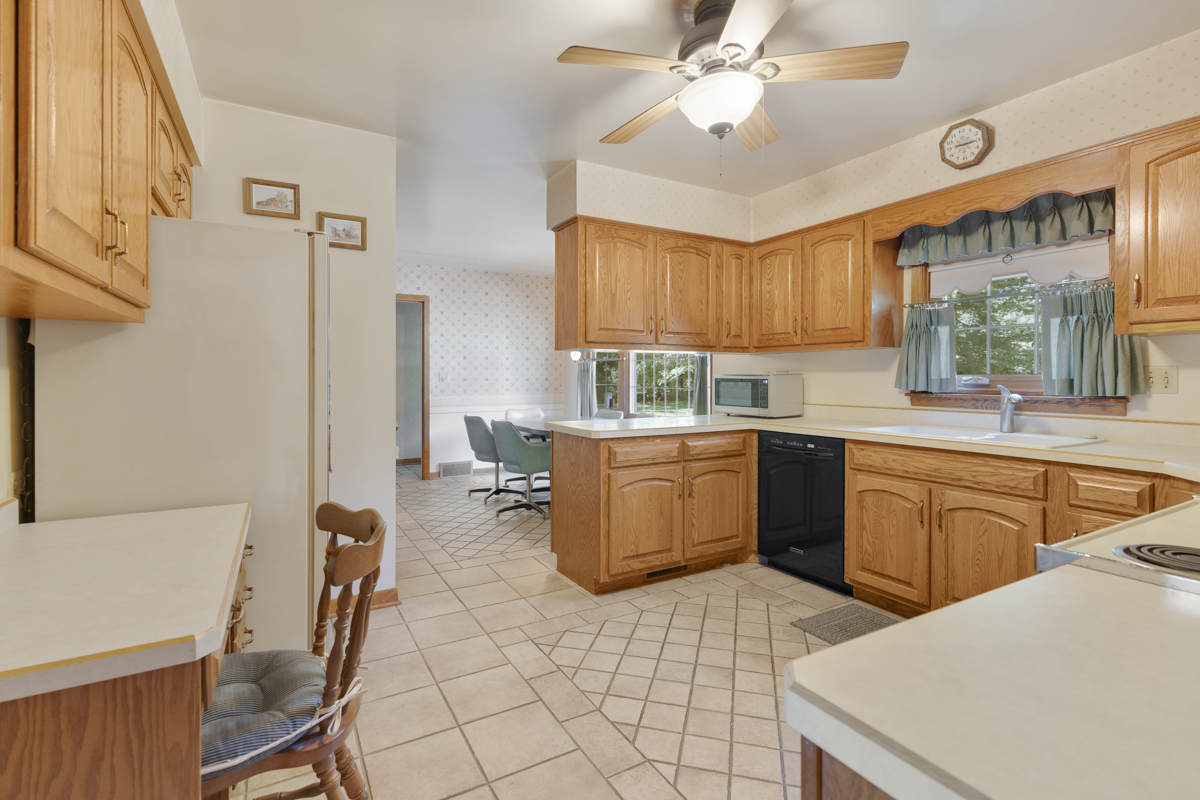 690 Stanford Drive Marengo, IL 60152 - Photo 8 of 30 a kitchen with a sink a stove cabinets dining table and utility