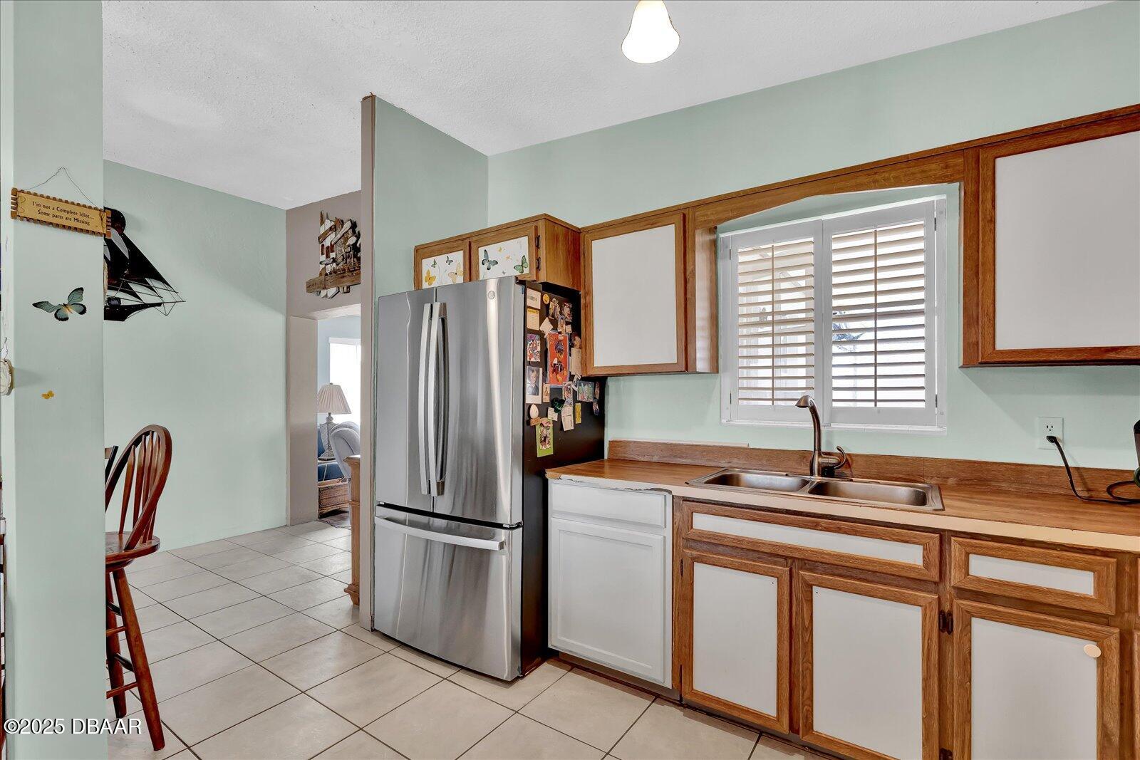 34 Dolphin Avenue Ormond Beach, FL 32176 - Photo 13 of 52 a kitchen with stainless steel appliances granite countertop a refrigerator and a sink