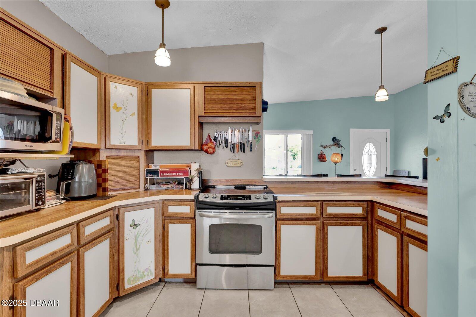 34 Dolphin Avenue Ormond Beach, FL 32176 - Photo 14 of 52 a kitchen with stainless steel appliances granite countertop a stove a sink and a refrigerator