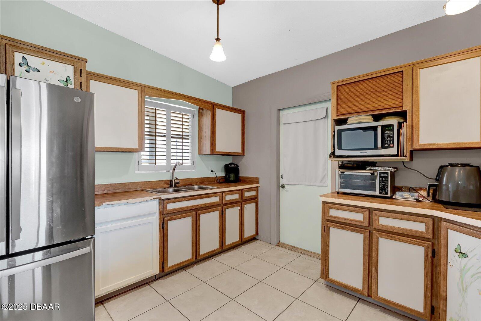 34 Dolphin Avenue Ormond Beach, FL 32176 - Photo 15 of 52 a kitchen with stainless steel appliances granite countertop a refrigerator and a stove top oven