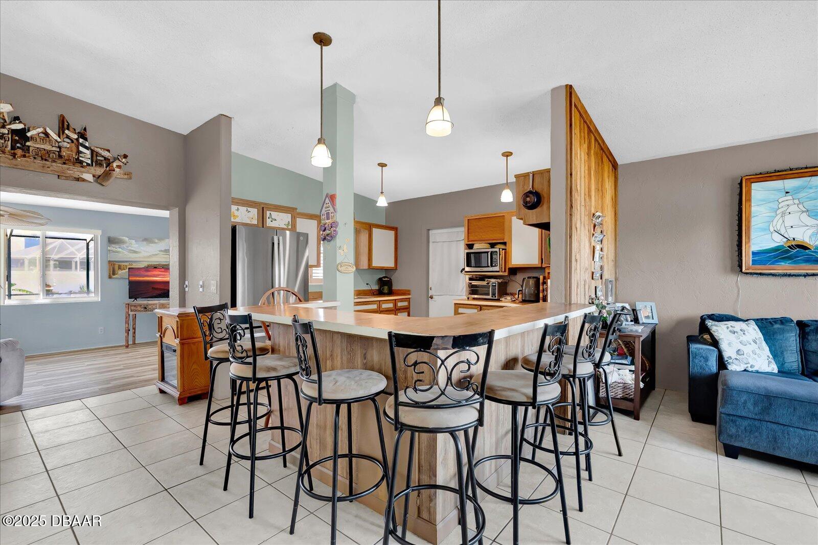 34 Dolphin Avenue Ormond Beach, FL 32176 - Photo 16 of 52 a view of a dining room with furniture and chandelier