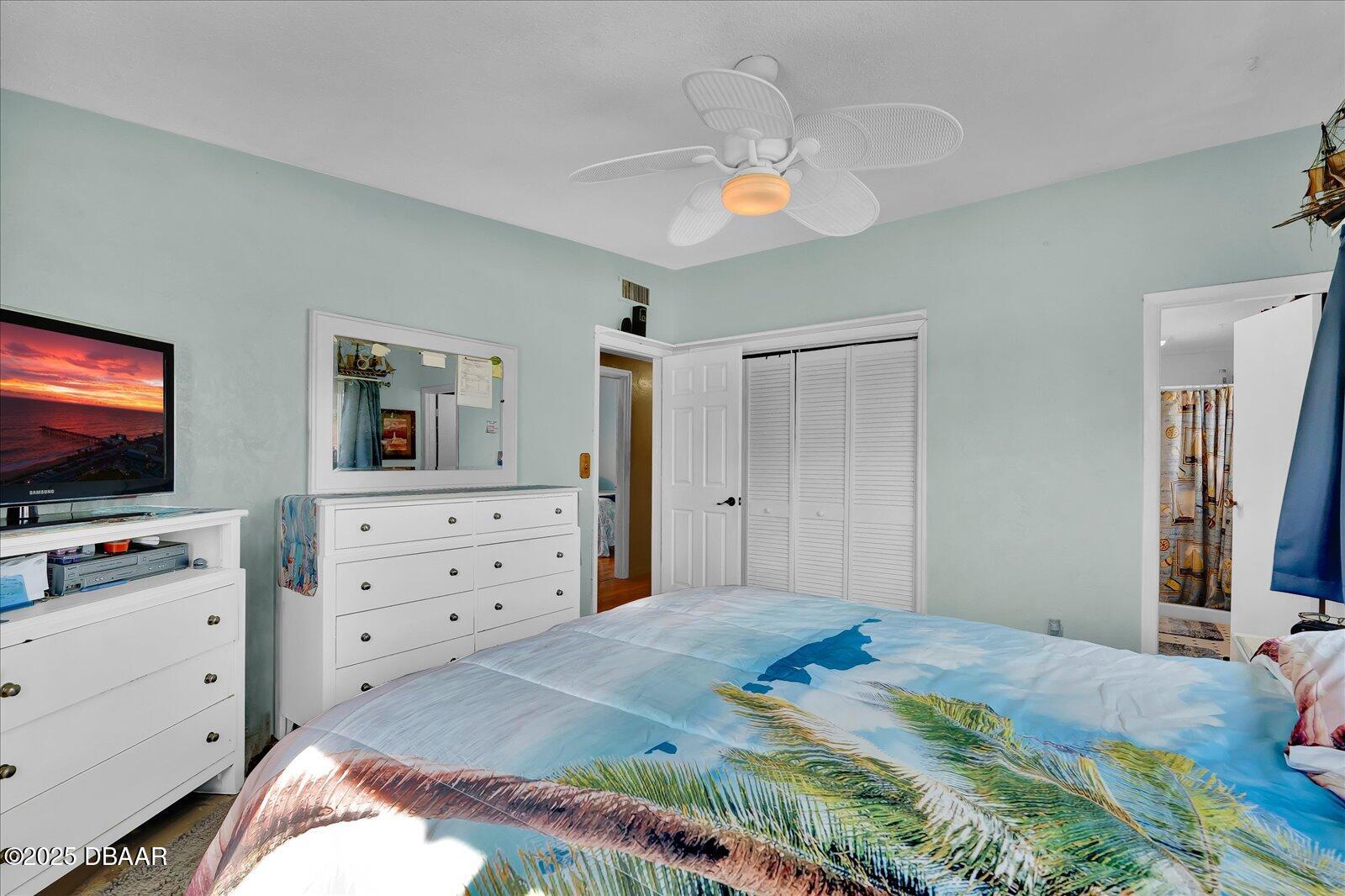 34 Dolphin Avenue Ormond Beach, FL 32176 - Photo 18 of 52 a bedroom with a bed and a flat screen tv