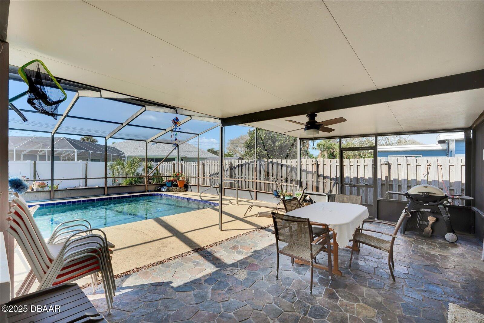 34 Dolphin Avenue Ormond Beach, FL 32176 - Photo 28 of 52 a dining room with furniture and a floor to ceiling window