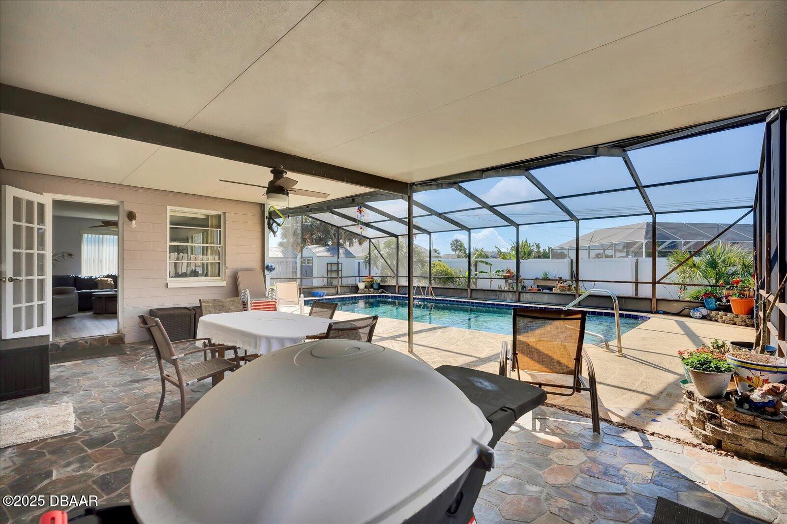 34 Dolphin Avenue Ormond Beach, FL 32176 - Photo 29 of 52 a living room with patio furniture and a potted plant