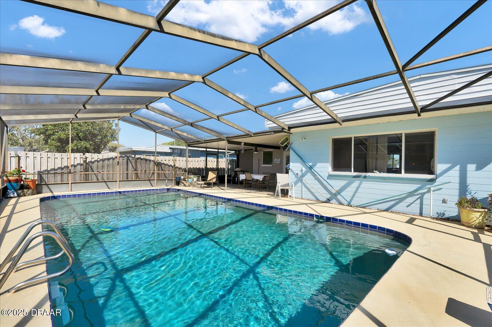 34 Dolphin Avenue Ormond Beach, FL 32176 - Photo 32 of 52 a view of a backyard with table and chairs under an umbrella
