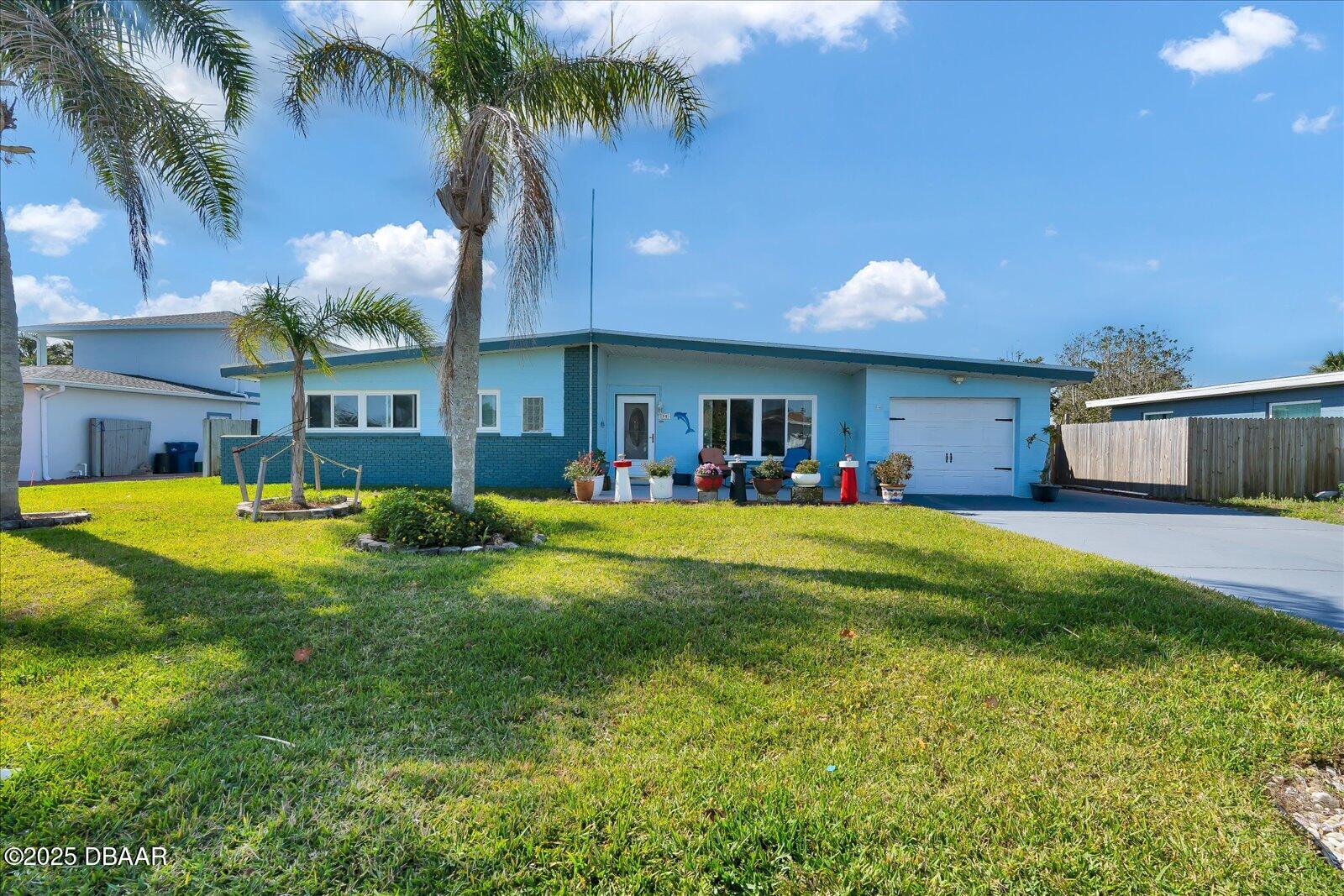 34 Dolphin Avenue Ormond Beach, FL 32176 - Photo 49 of 52 a front view of house with yard and outdoor seating