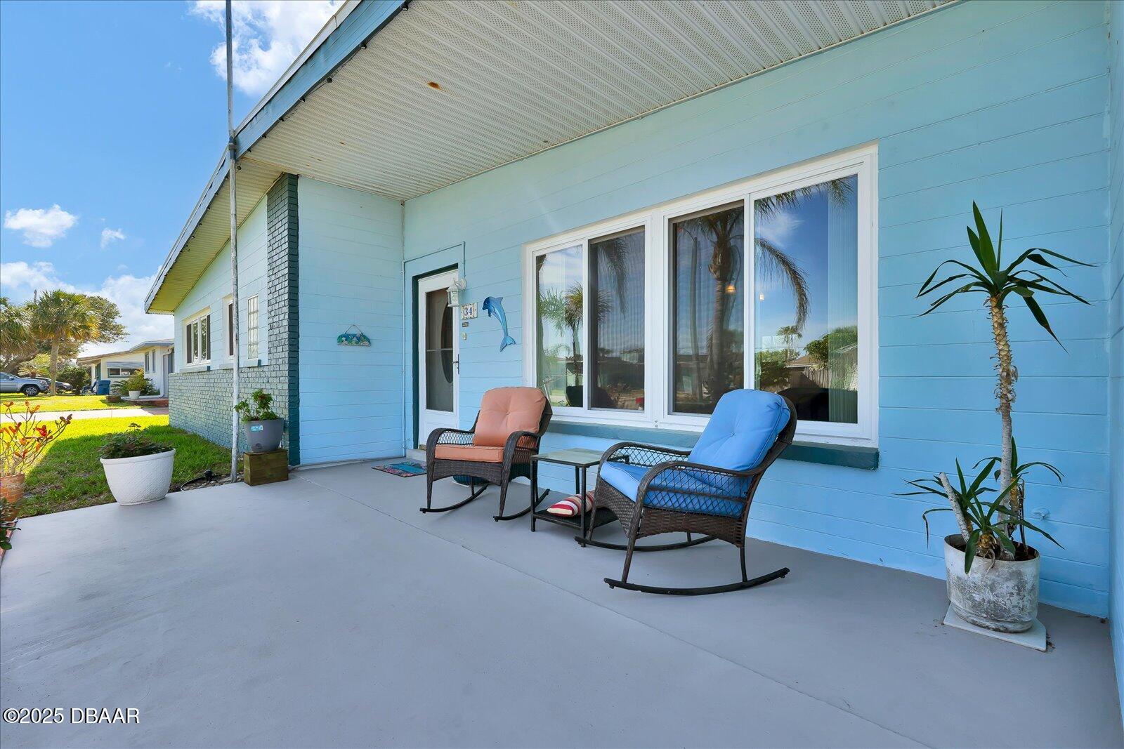 34 Dolphin Avenue Ormond Beach, FL 32176 - Photo 51 of 52 a building outdoor space with furniture and potted plants