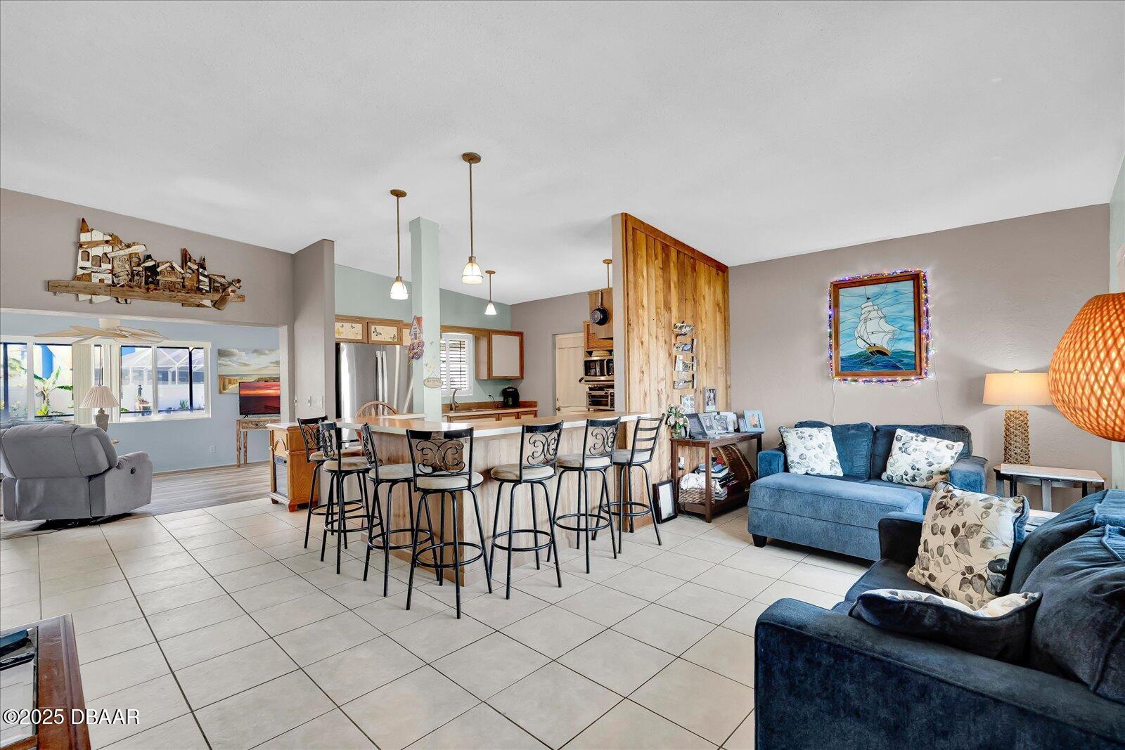 34 Dolphin Avenue Ormond Beach, FL 32176 - Photo 6 of 52 a living room with furniture and a large window