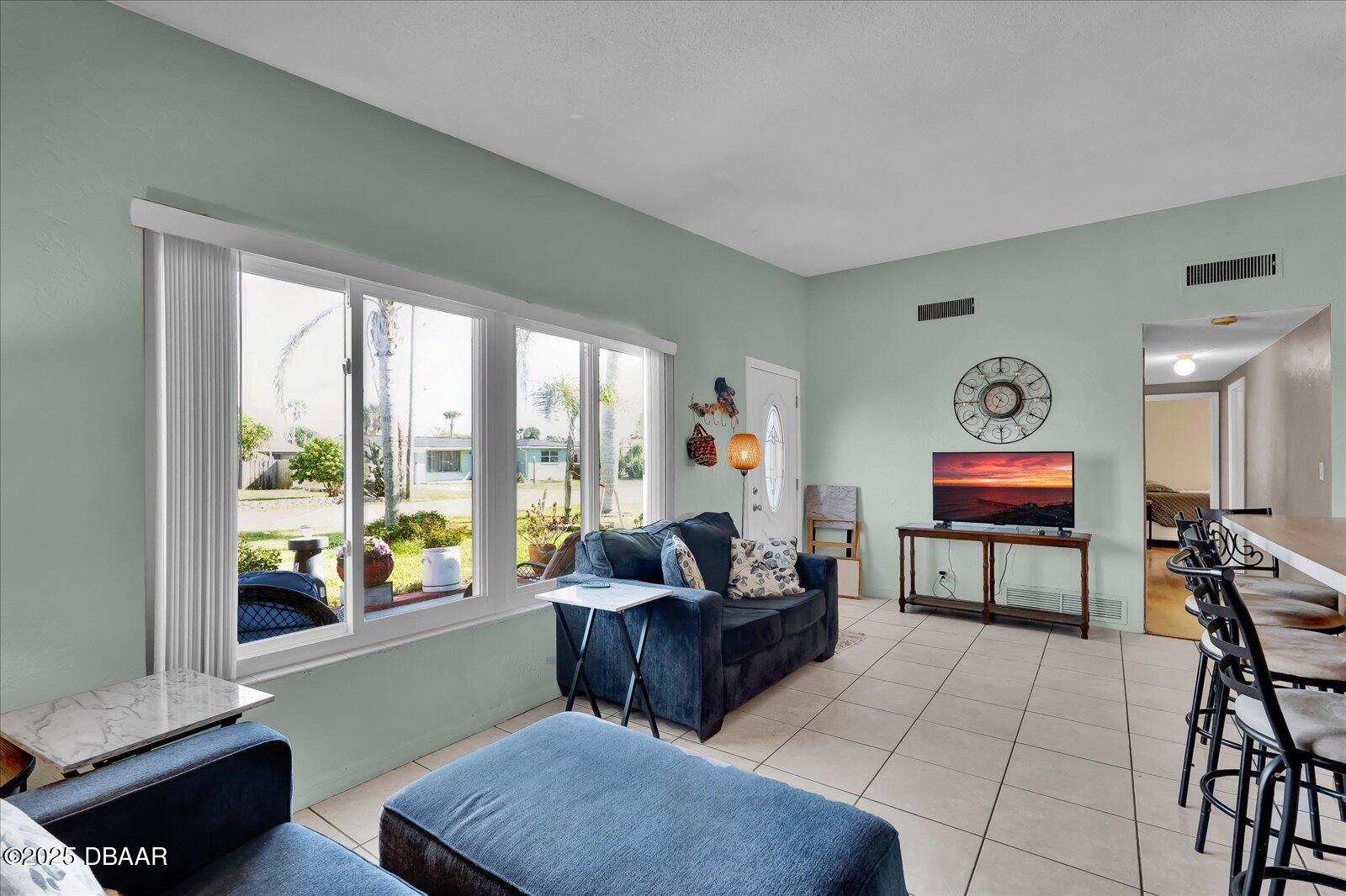 34 Dolphin Avenue Ormond Beach, FL 32176 - Photo 9 of 52 a living room with furniture and a large window