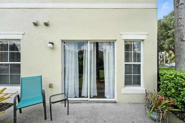 a view of a house with porch and chairs