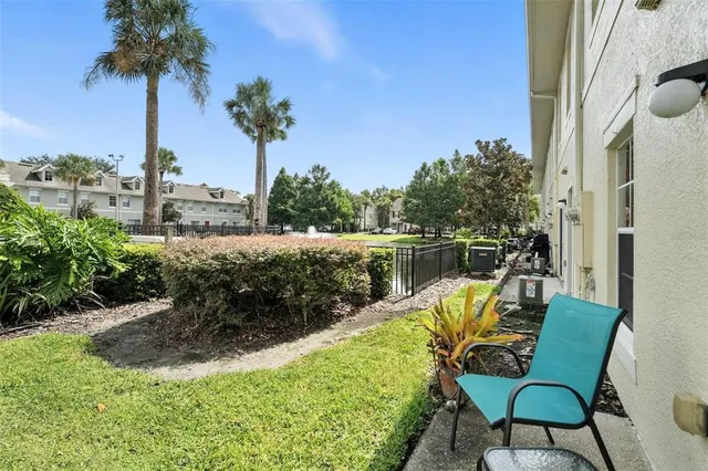 a view of a chair and tables in the patio with a lake view