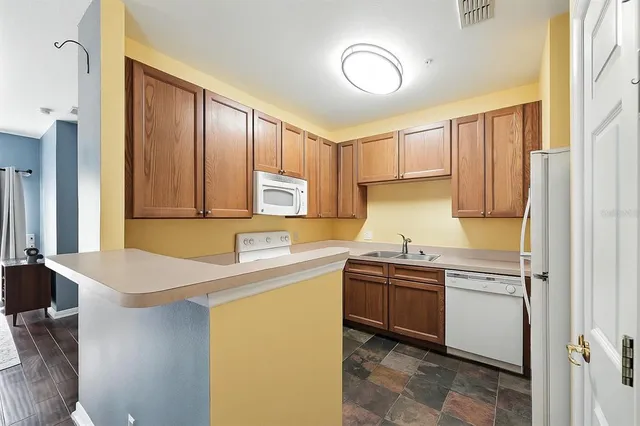 a kitchen with stainless steel appliances granite countertop a sink and cabinets