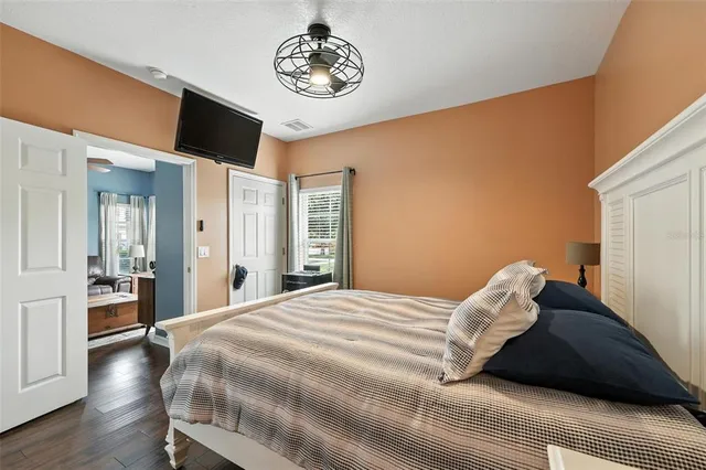 a bedroom with a bed and a flat screen tv