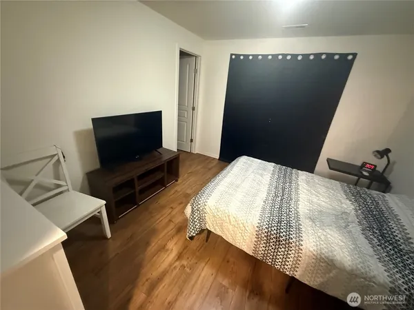 a bedroom with a bed and flat screen tv