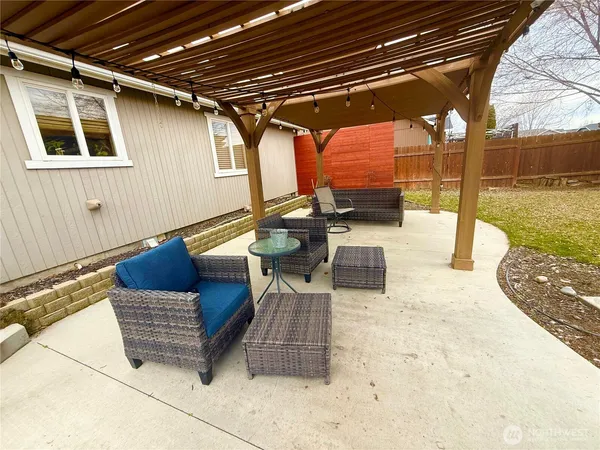 a roof deck with couch and chairs