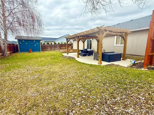a view of a house with backyard and sitting area