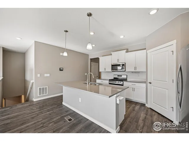 a kitchen with stainless steel appliances granite countertop a stove and a refrigerator