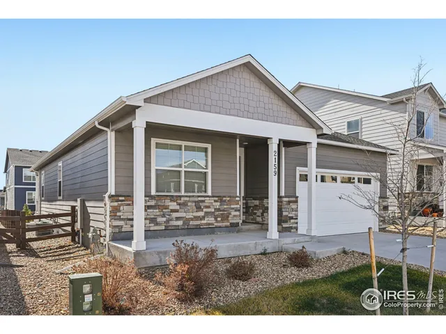 a view of an empty room with exposed radiator and fireplace