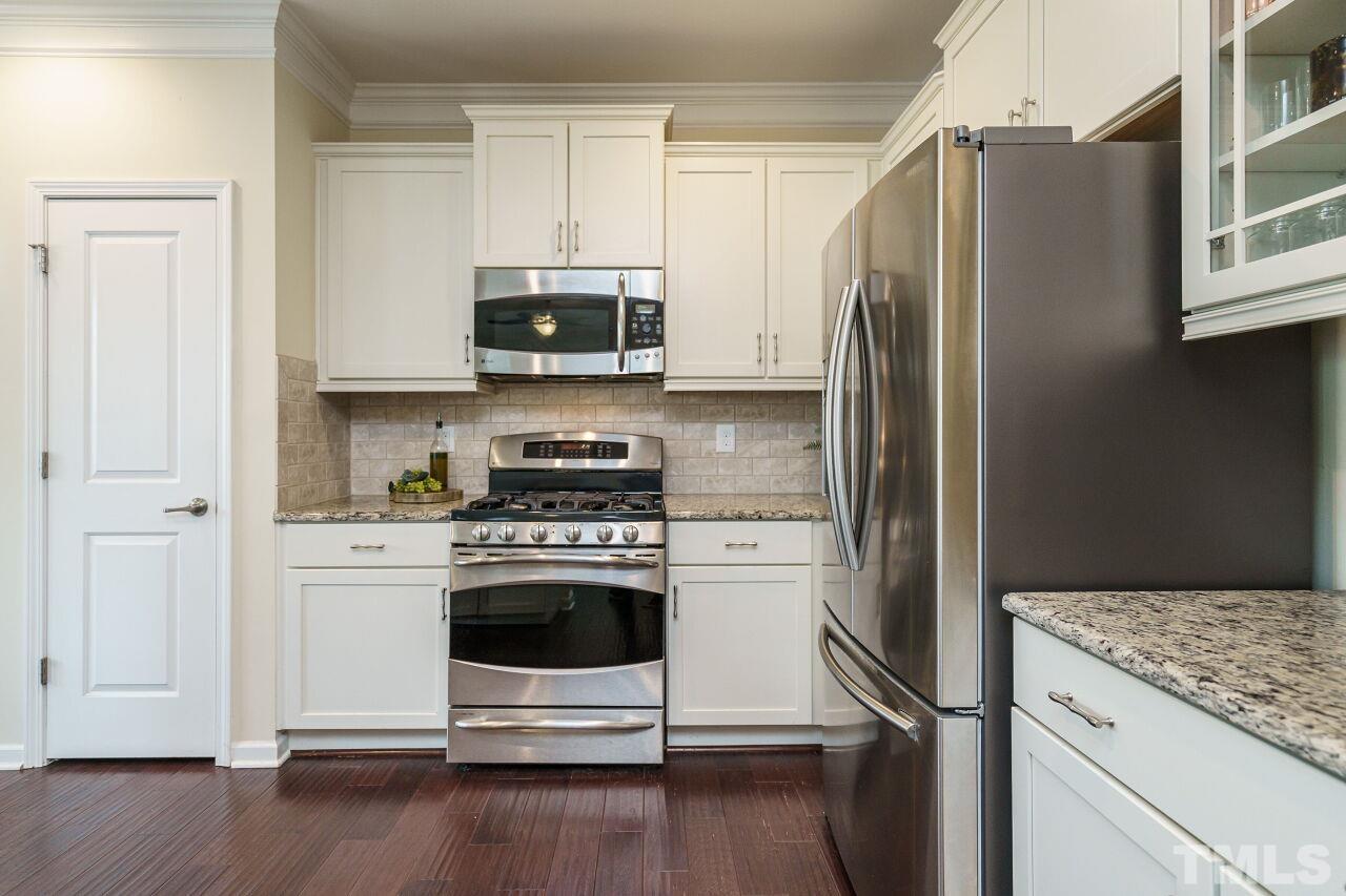 1568 Rodessa Run Raleigh, NC 27607 - Photo 11 of 25 a kitchen with stainless steel appliances white cabinets and a refrigerator