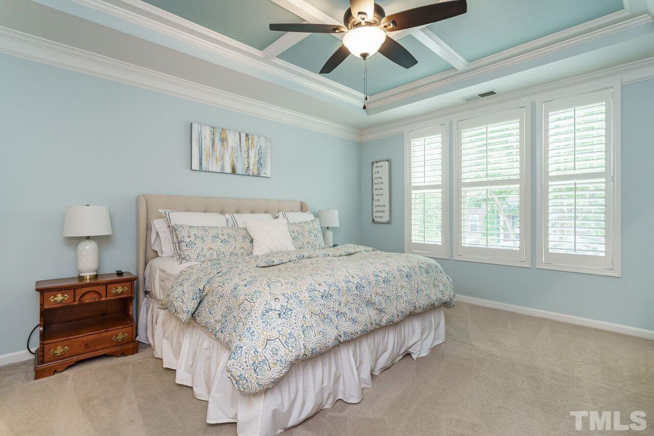 1568 Rodessa Run Raleigh, NC 27607 - Photo 14 of 25 a bedroom with a bed and a chandelier
