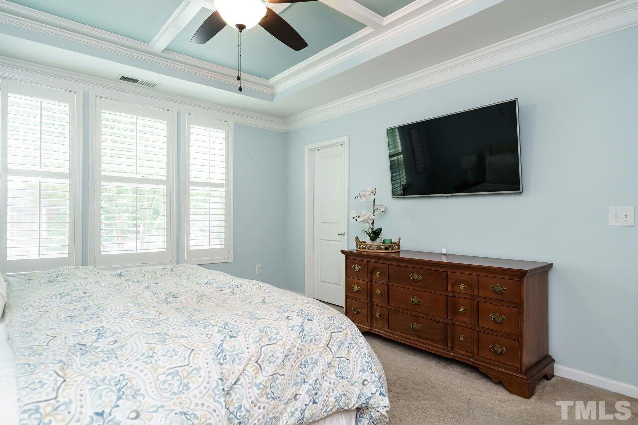 1568 Rodessa Run Raleigh, NC 27607 - Photo 15 of 25 a bedroom with a bed a flat screen tv and a chandelier
