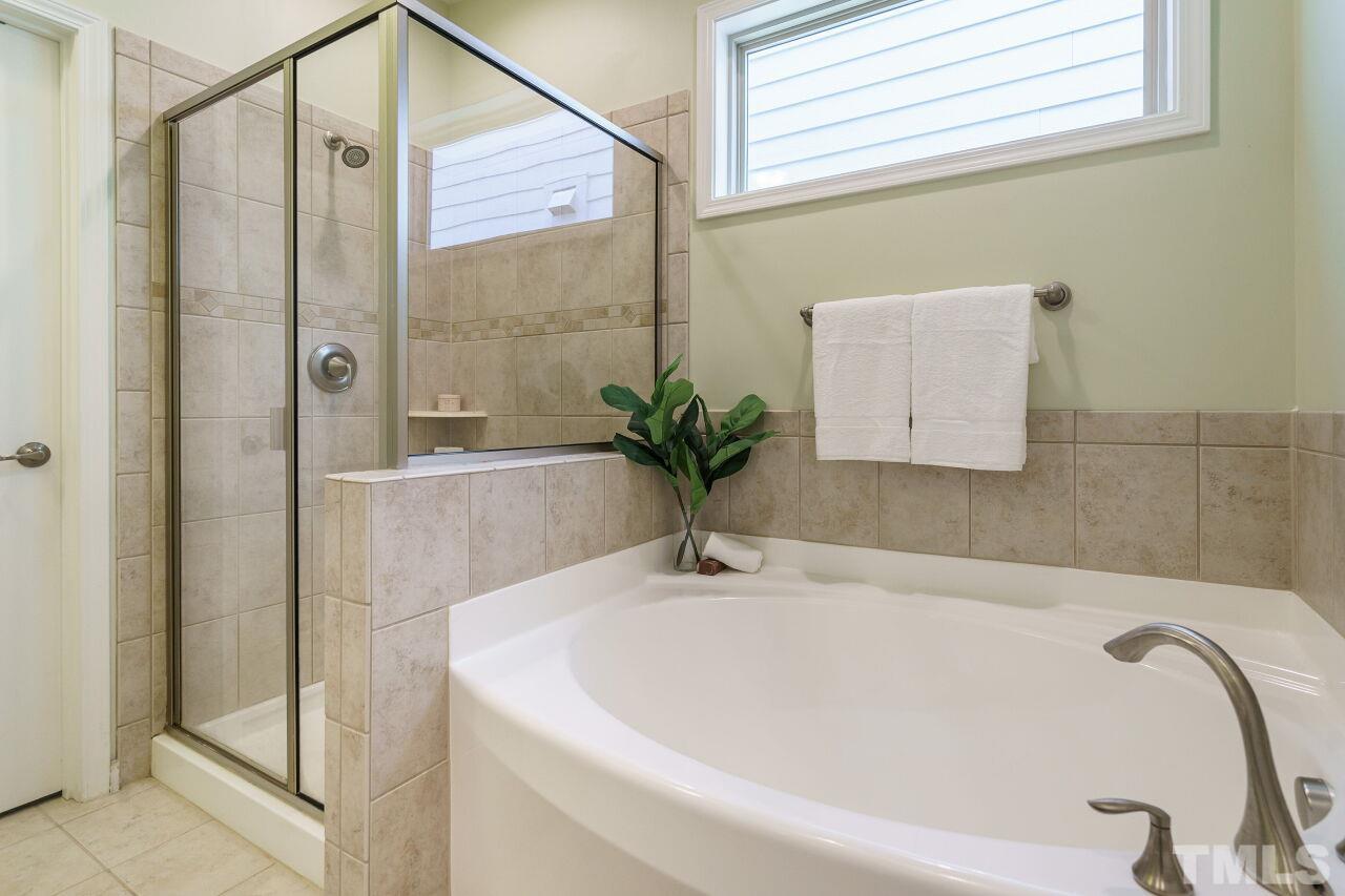 1568 Rodessa Run Raleigh, NC 27607 - Photo 17 of 25 a white bath tub sitting next to a shower