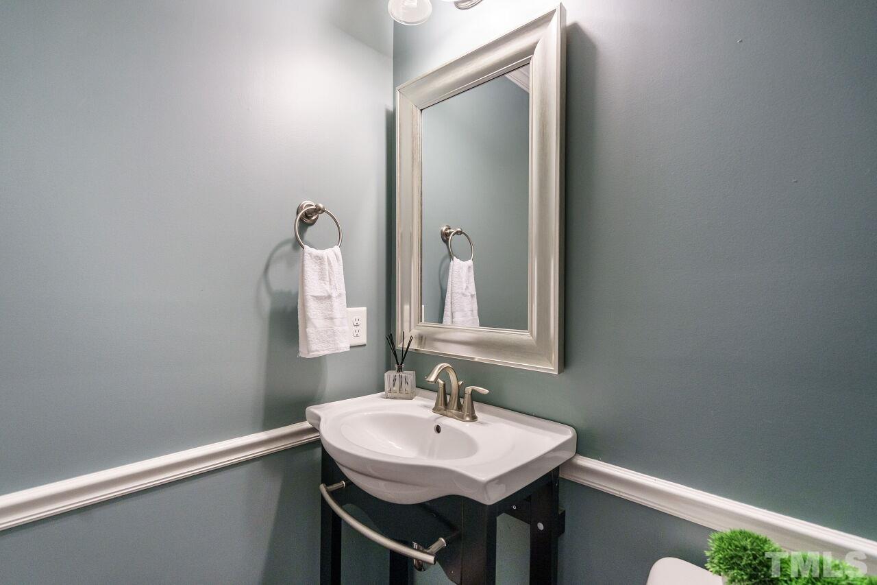 1568 Rodessa Run Raleigh, NC 27607 - Photo 18 of 25 a bathroom with a sink and a mirror