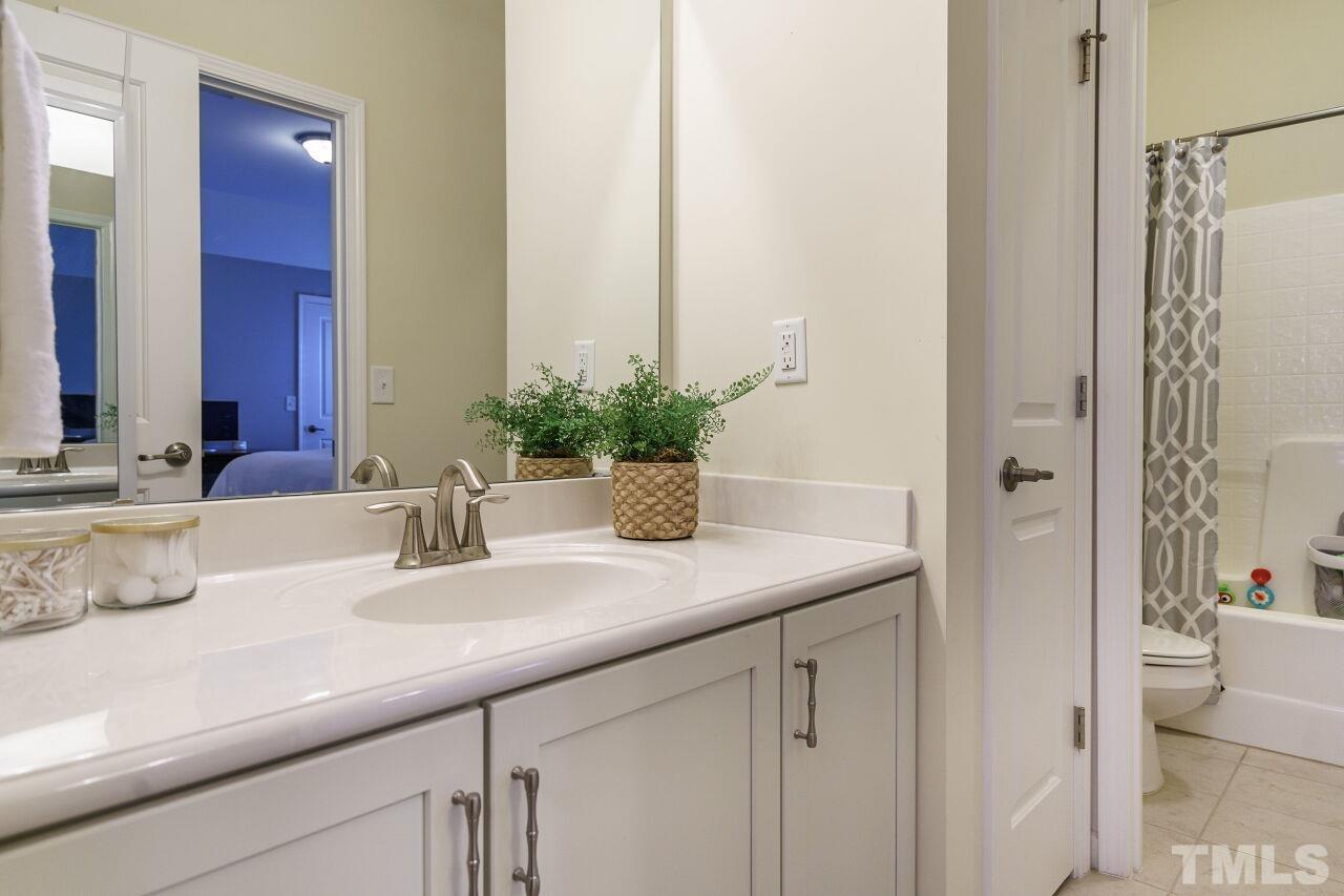 1568 Rodessa Run Raleigh, NC 27607 - Photo 21 of 25 a bathroom with a sink and a mirror