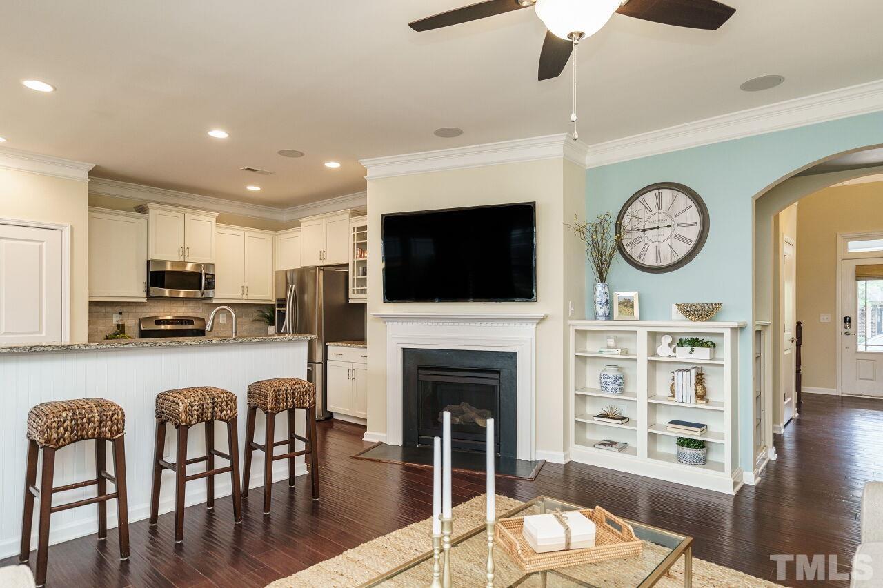 1568 Rodessa Run Raleigh, NC 27607 - Photo 7 of 25 a living room with furniture a fireplace and a flat screen tv