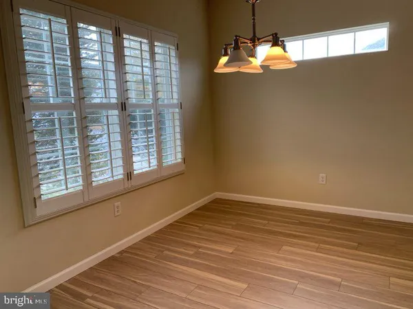 a view of a room with wooden floor and windows
