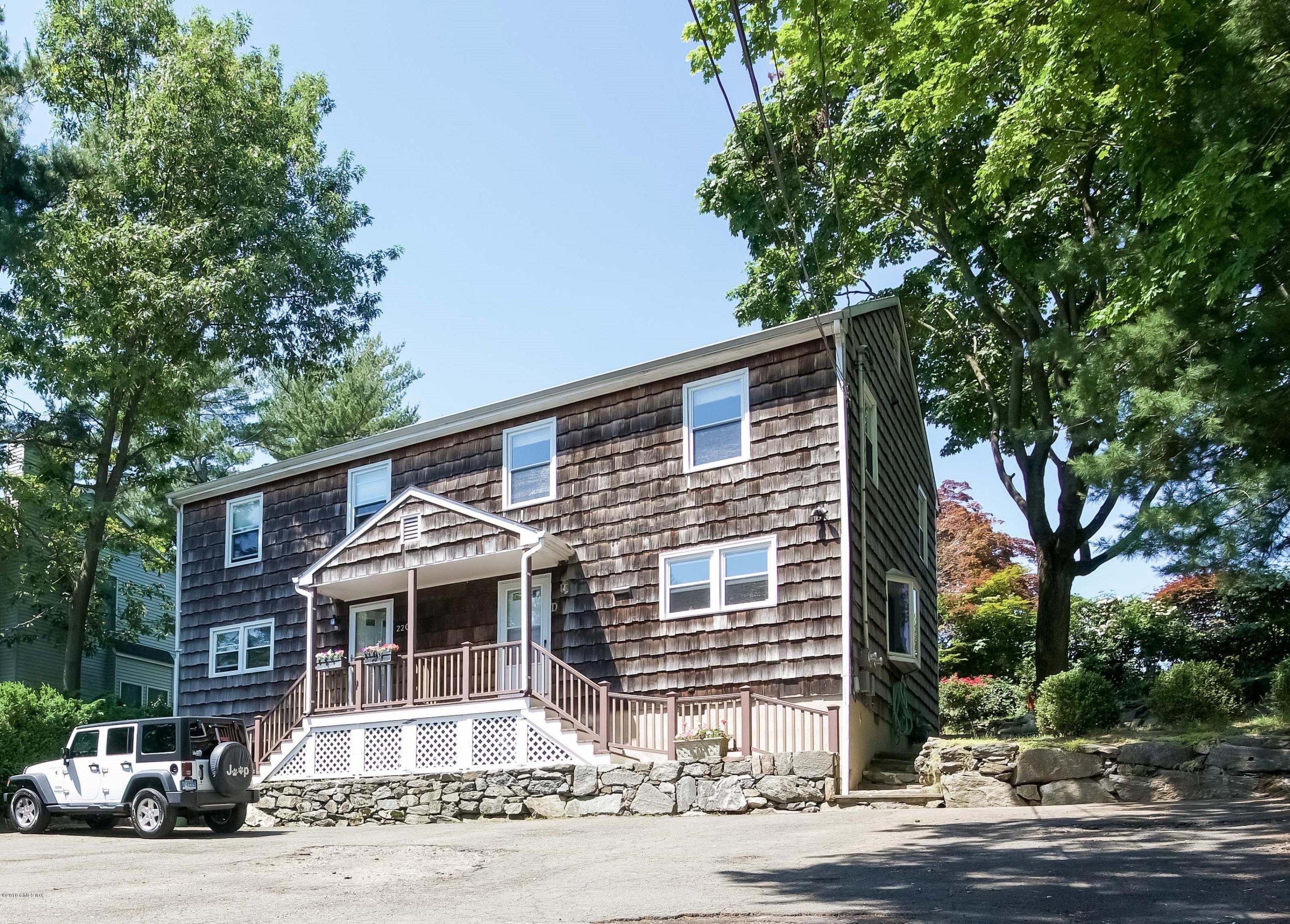 22 Livingston Place, Unit D Greenwich, CT 06830 - Photo 1 of 17 a front view of a house with a garden