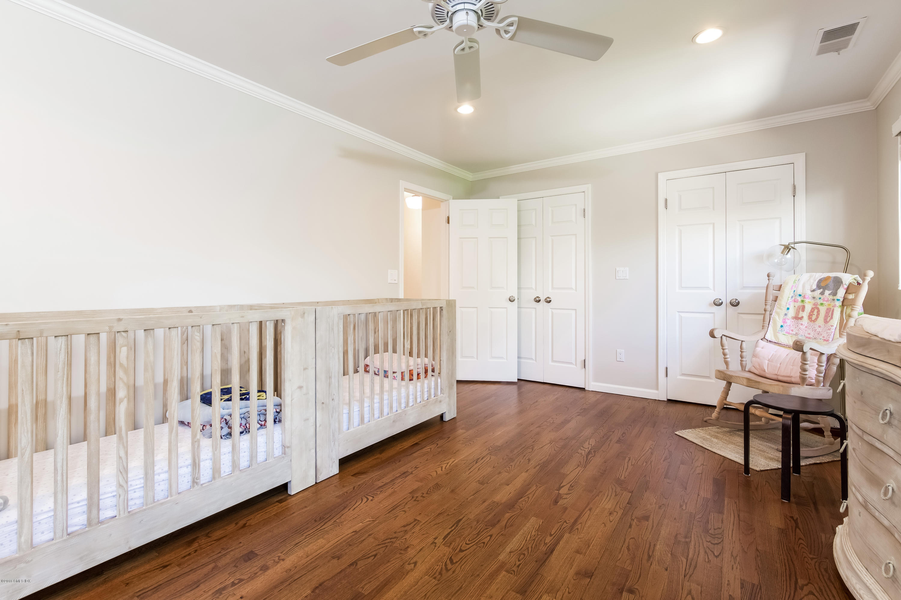 22 Livingston Place, Unit D Greenwich, CT 06830 - Photo 11 of 17 a view of a room with wooden floor staircase and a ceiling fan
