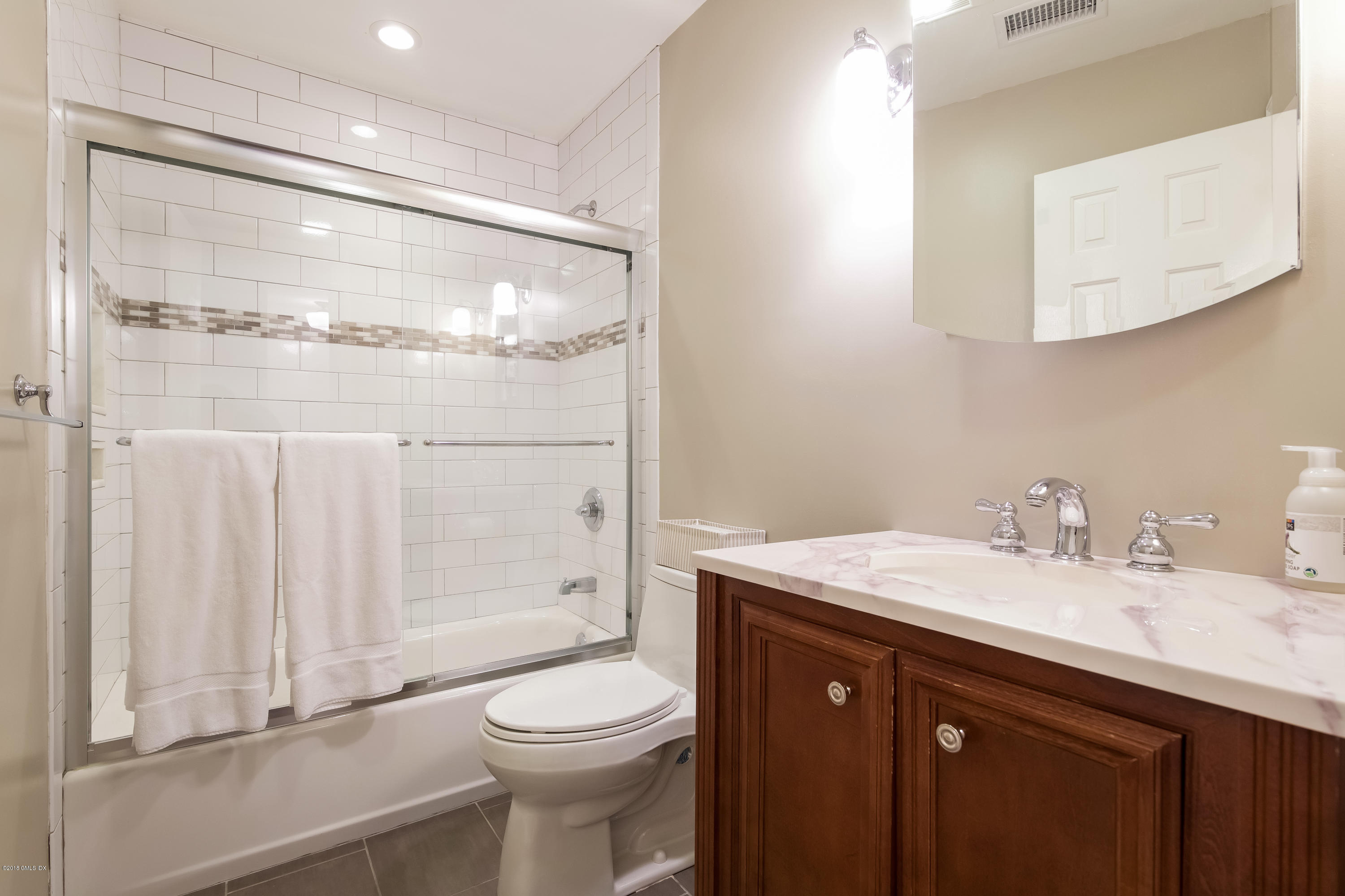 22 Livingston Place, Unit D Greenwich, CT 06830 - Photo 13 of 17 a bathroom with a sink a toilet and shower