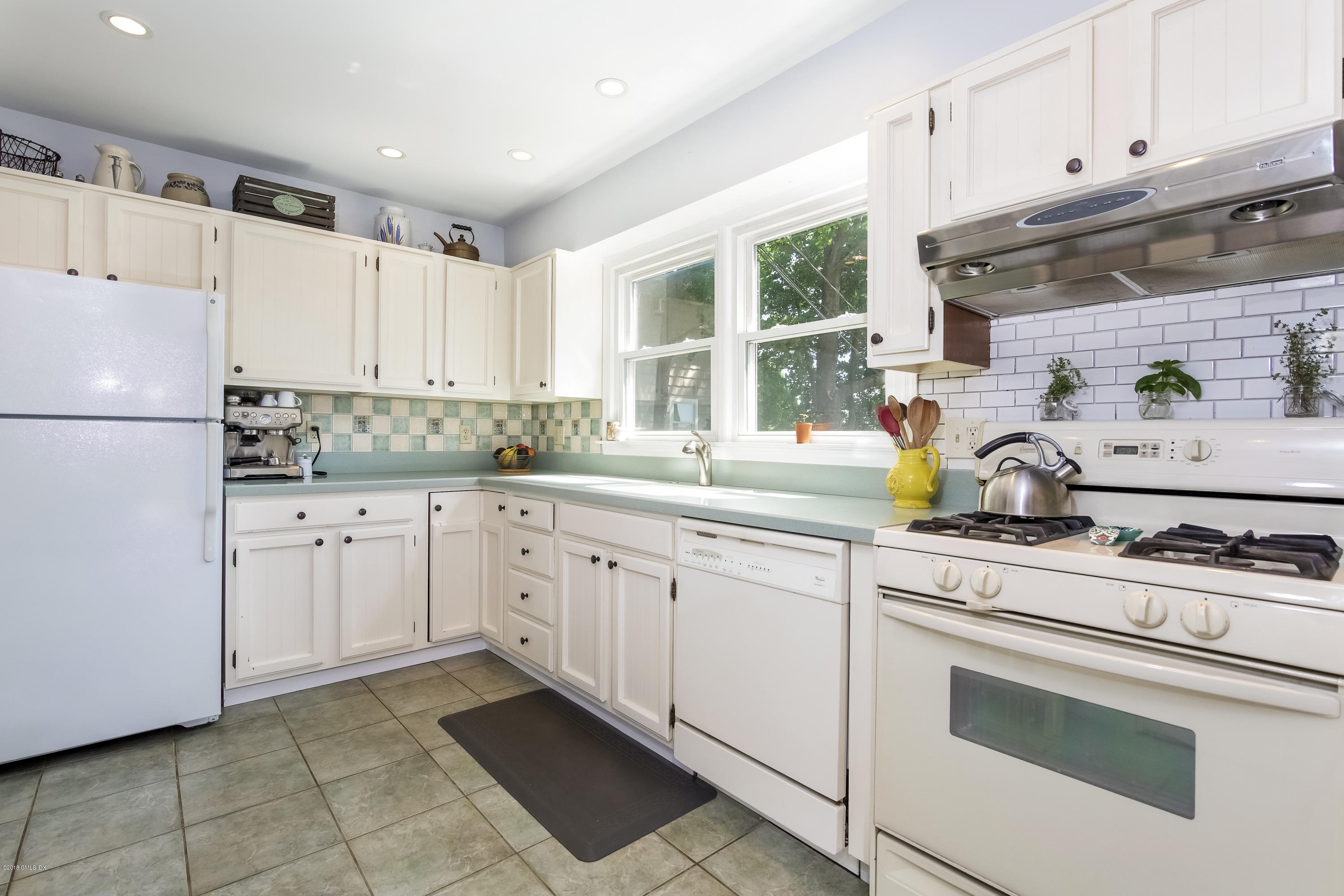 22 Livingston Place, Unit D Greenwich, CT 06830 - Photo 5 of 17 a kitchen with granite countertop a sink stainless steel appliances and cabinets