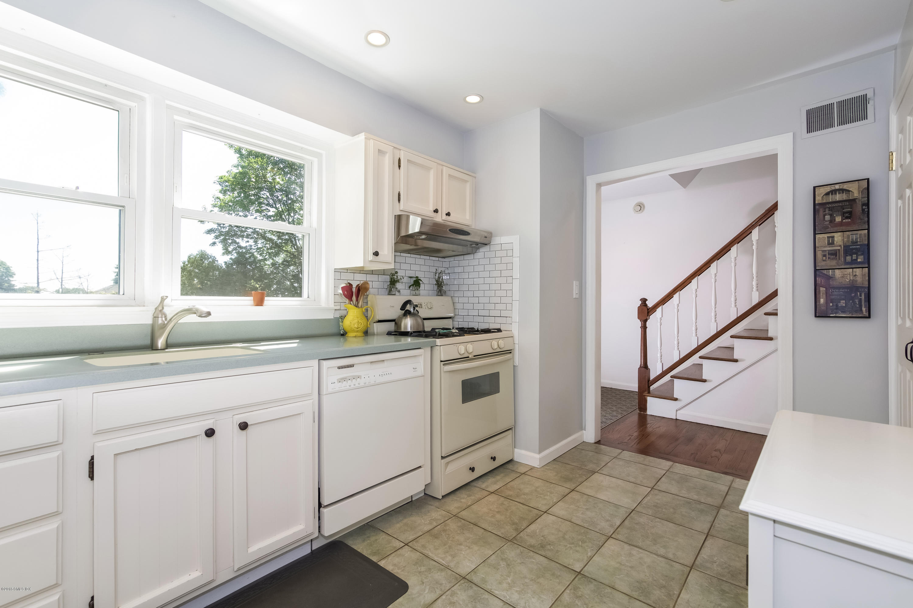 22 Livingston Place, Unit D Greenwich, CT 06830 - Photo 6 of 17 a kitchen with white cabinets and white appliances