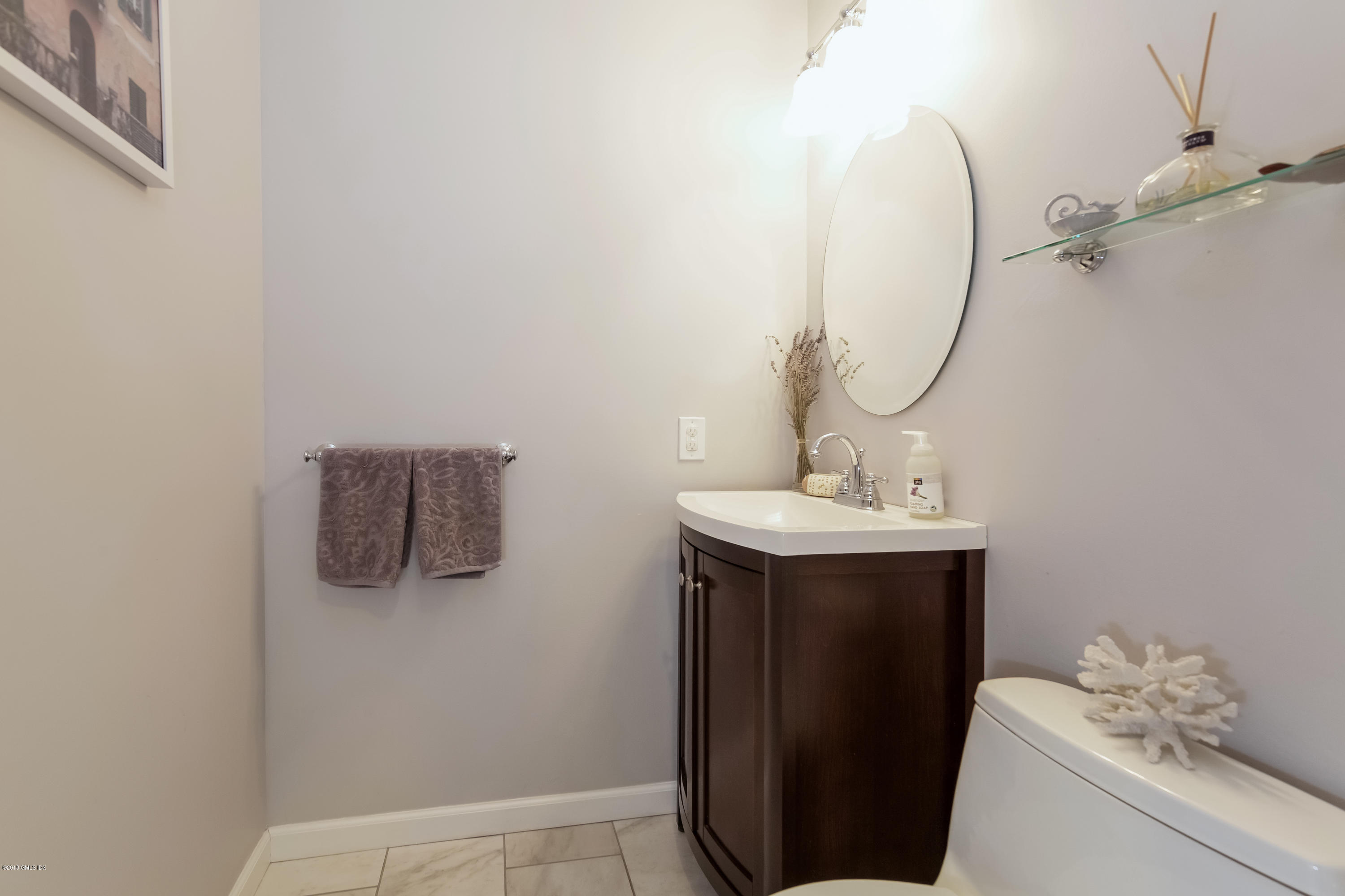 22 Livingston Place, Unit D Greenwich, CT 06830 - Photo 7 of 17 a bathroom with a sink and mirror