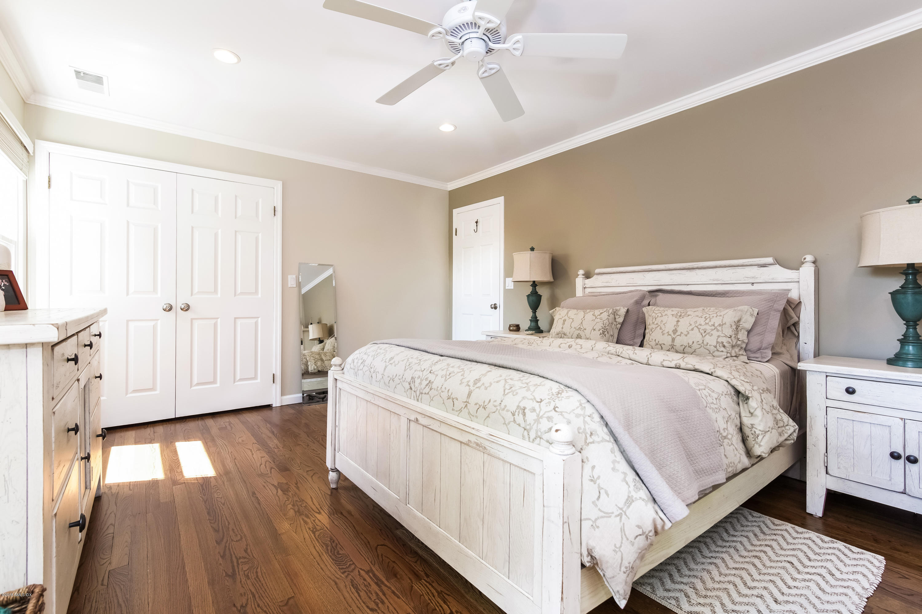 22 Livingston Place, Unit D Greenwich, CT 06830 - Photo 8 of 17 a spacious bedroom with a bed and a chandelier