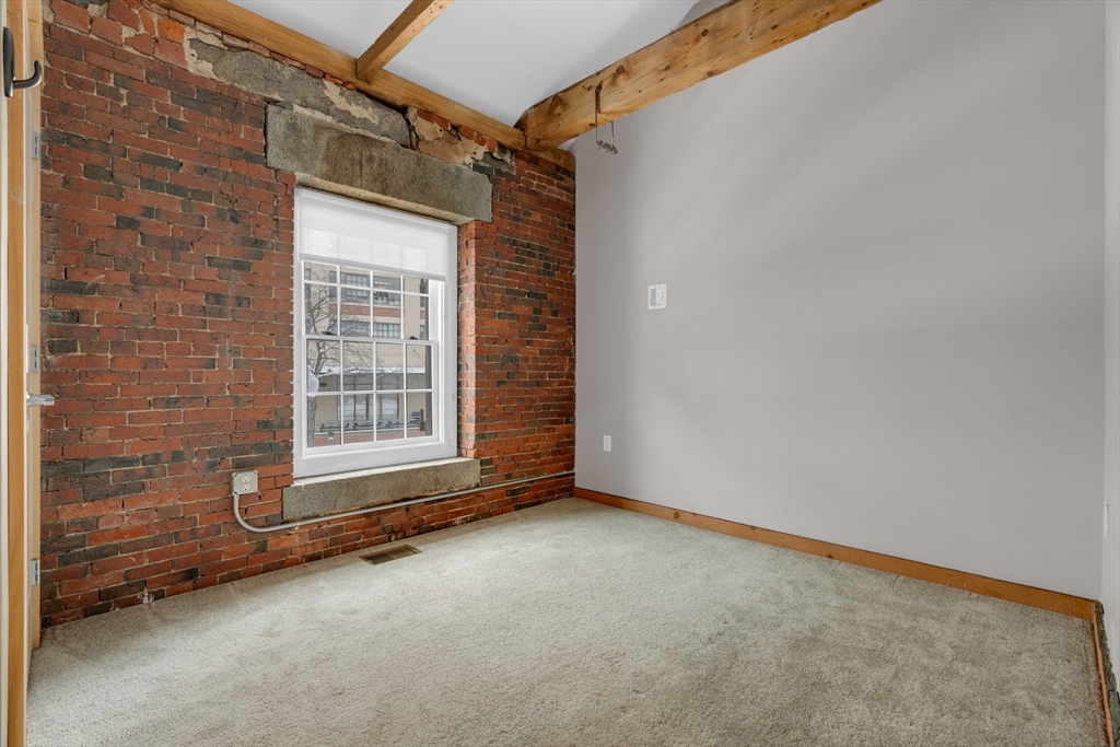 58 13th Street, Unit T105 Boston, MA 02129 - Photo 8 of 15 a view of a room with wooden walls and windows