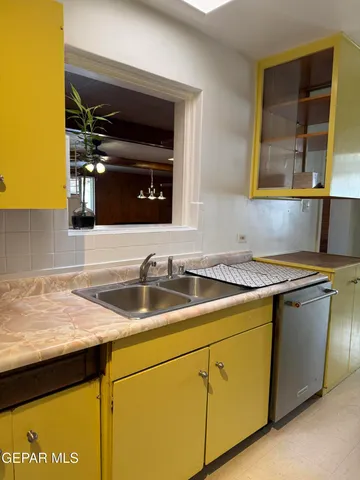 a kitchen with granite countertop a sink and a stove top oven