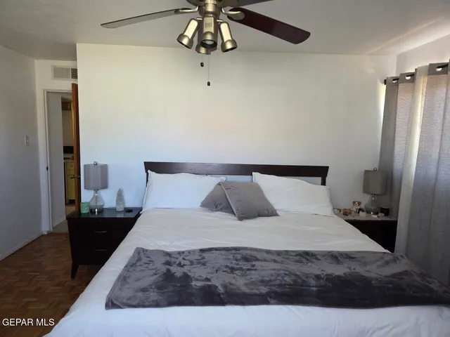 a large bed in a bedroom next to a window