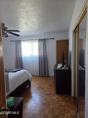 a bedroom with a bed and a mirror