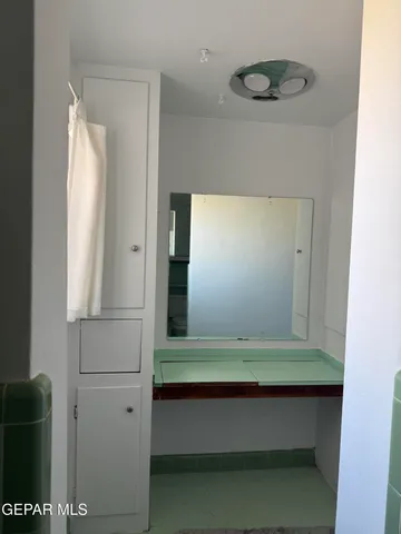 a bathroom with a mirror and a shower