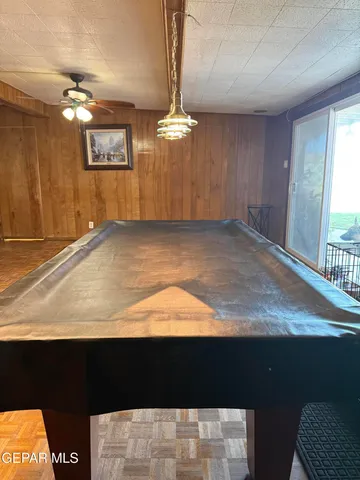 a living room with furniture pool table table and chairs