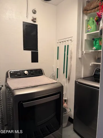 a view of a big house with a big yard potted plants and large tree