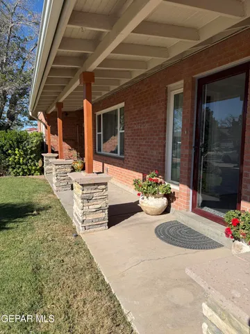 a view of a backyard with table and chairs potted plants