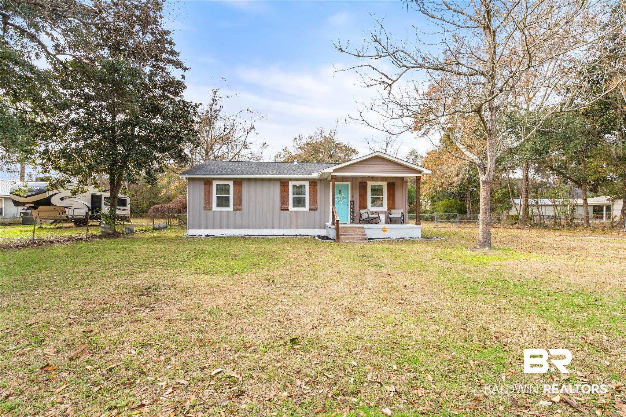 419 Pierce Street Saraland, AL 36571 - Photo 20 of 21 View of front of home with a front yard and covered porch