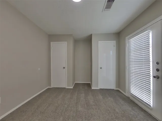 an empty room with a empty space and windows