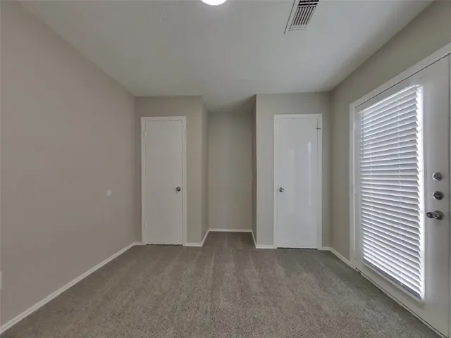 an empty room with a empty space and windows